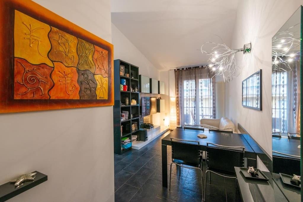 a living room with a table and a dining room at ROSA DEI VENTI in Santa Margherita Ligure