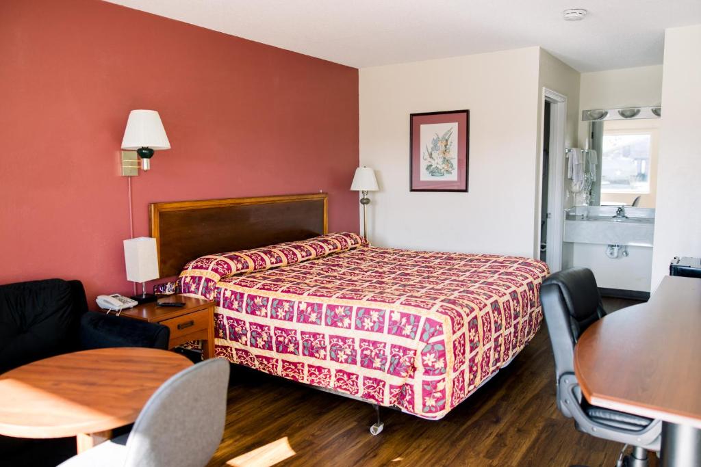 a hotel room with a bed and a table at Exclusive Quarters in Cleveland