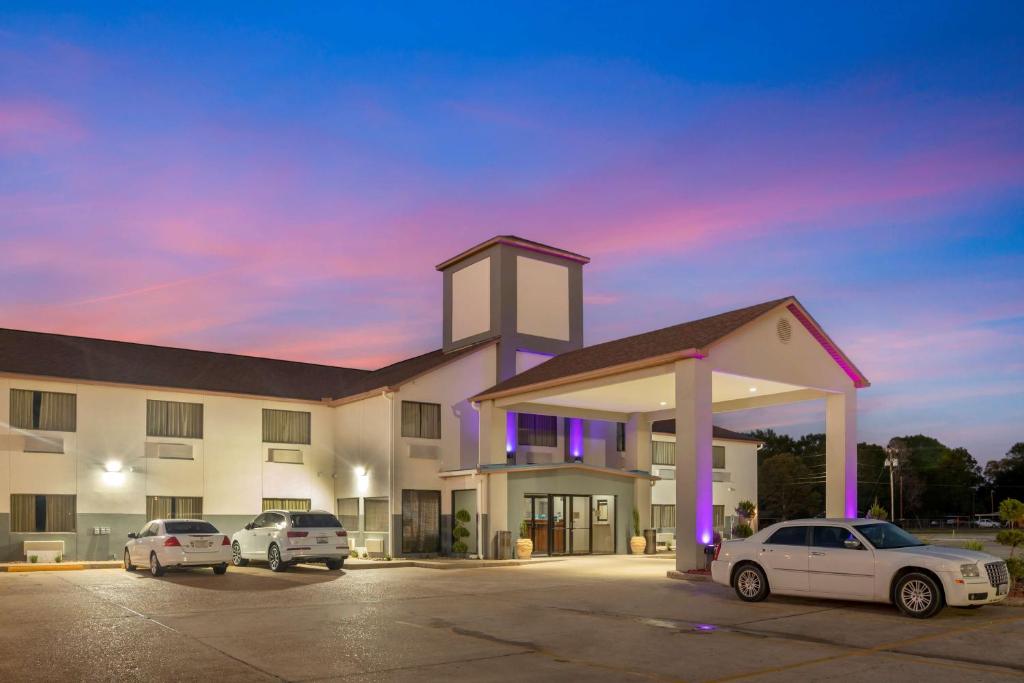 a large building with cars parked in a parking lot at Best Western Ville Platte in Ville Platte