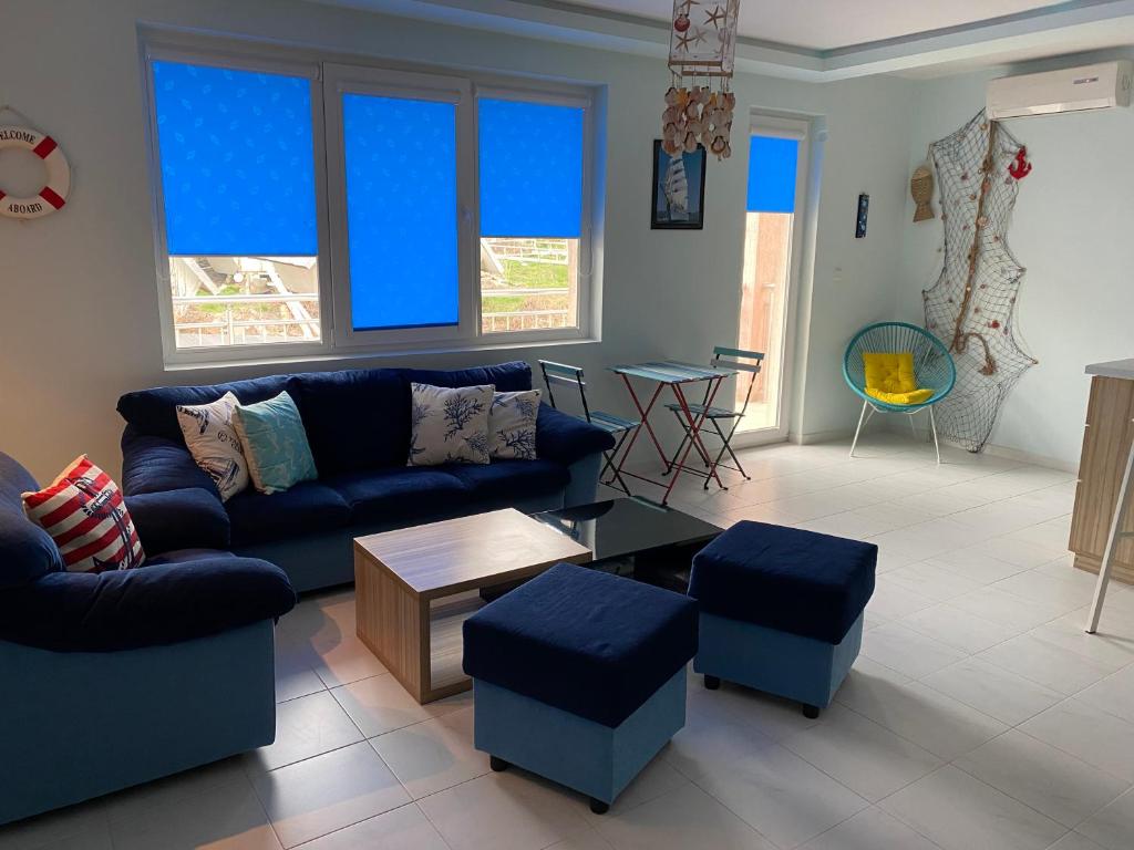 a living room with a blue couch and blue stools at Blue Lagoon apartment next to the centre Kranevo. in Kranevo