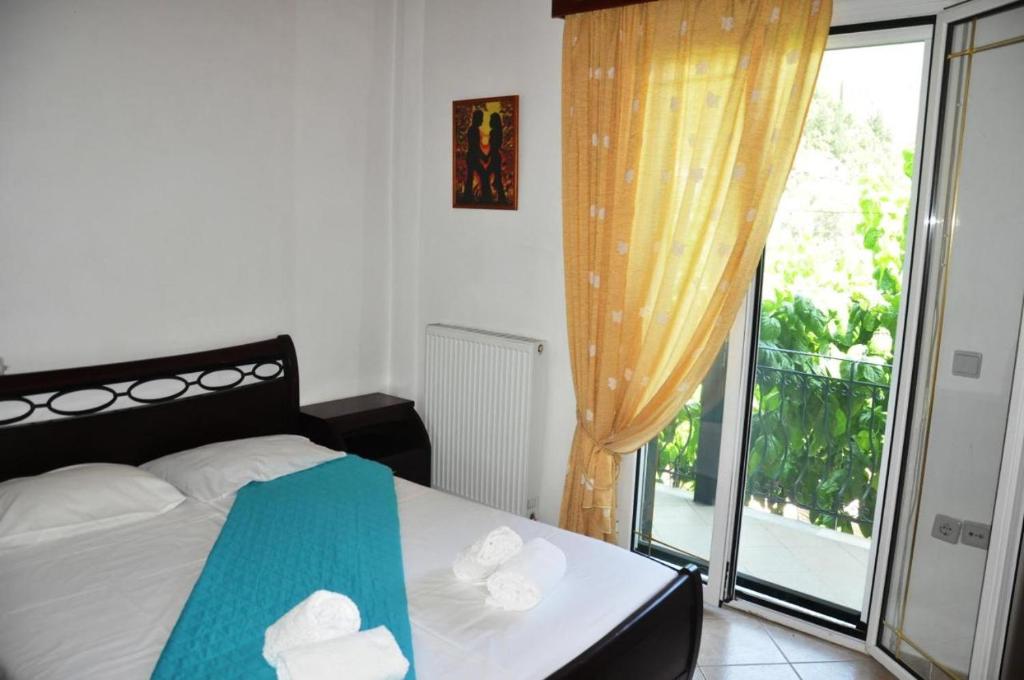 a bedroom with a bed and a large window at Verani Residence **New Listing Discount 20%** Balcony*Parking* in Sívros