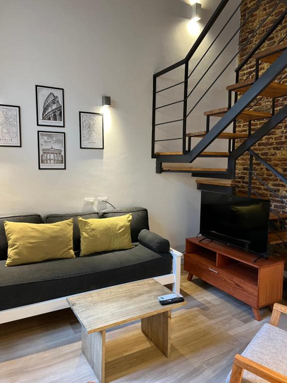 a living room with a couch and a wooden coffee table at Loft .Once de Abril in Bahía Blanca