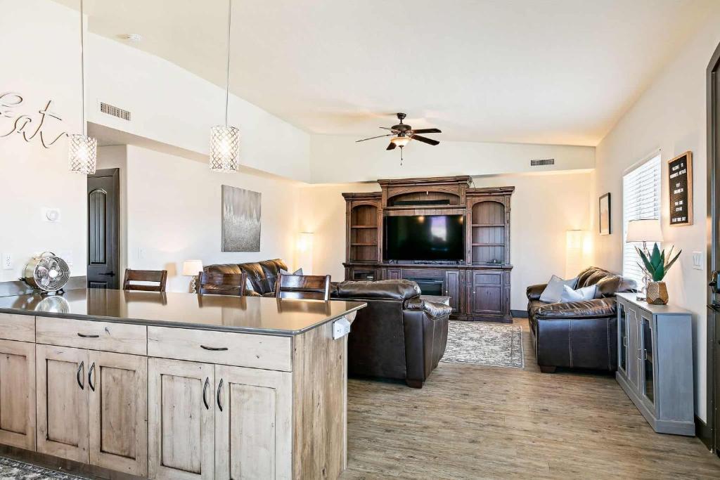 a kitchen and living room with a couch and a tv at Canthony's Cottage W301 condo in St. George