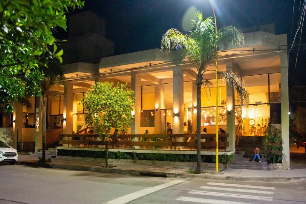 a building with a palm tree in front of it at Catalina Hotel San Pedro de Jujuy in San Pedro de Jujuy