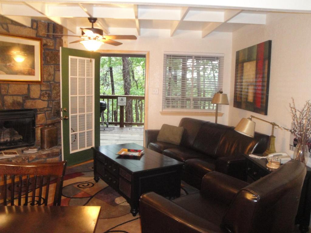 ein Wohnzimmer mit einem Sofa und einem Tisch in der Unterkunft Mountain Harbor Forest View Lodge cottage in Mount Ida