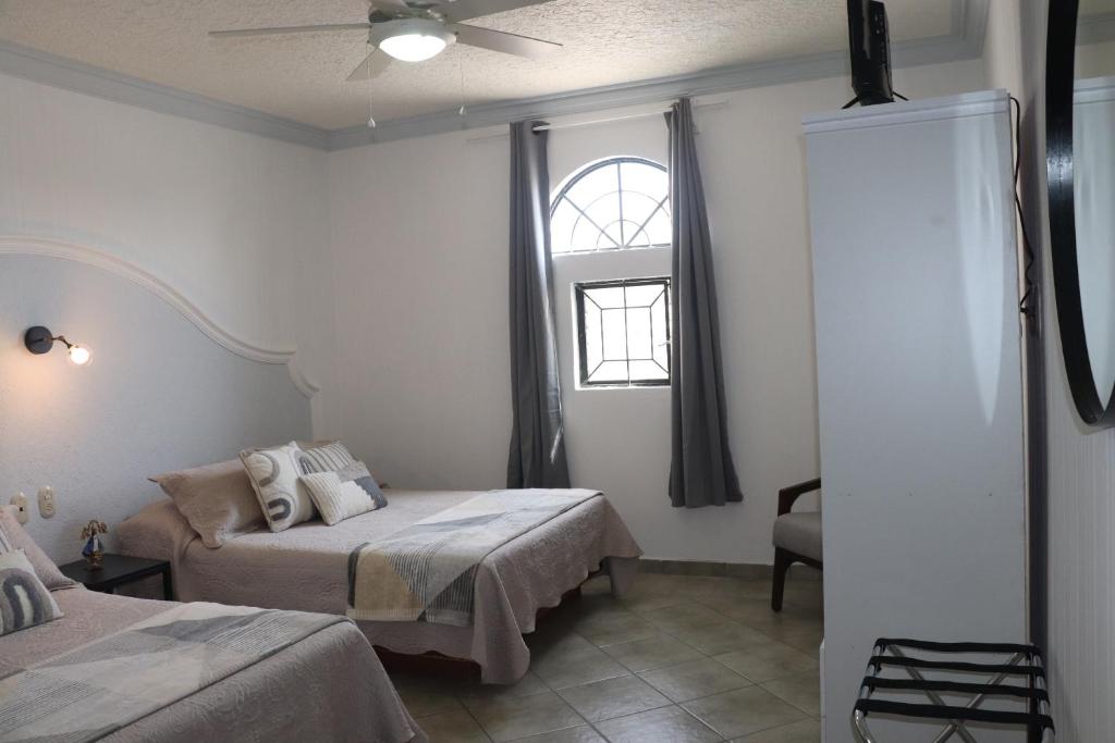 Postel nebo postele na pokoji v ubytování Hotel Plaza San Juan