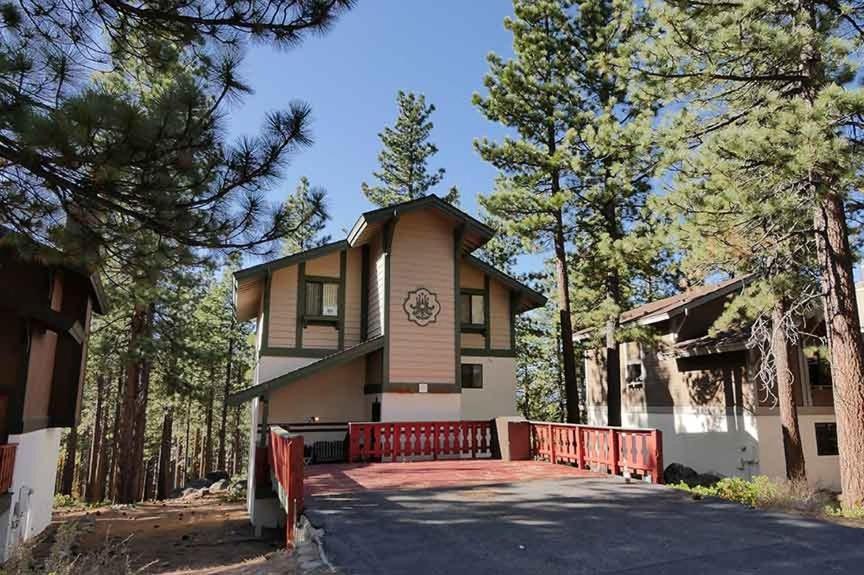 a house with a red fence in front of it at 1240 Timber Lane home in South Lake Tahoe
