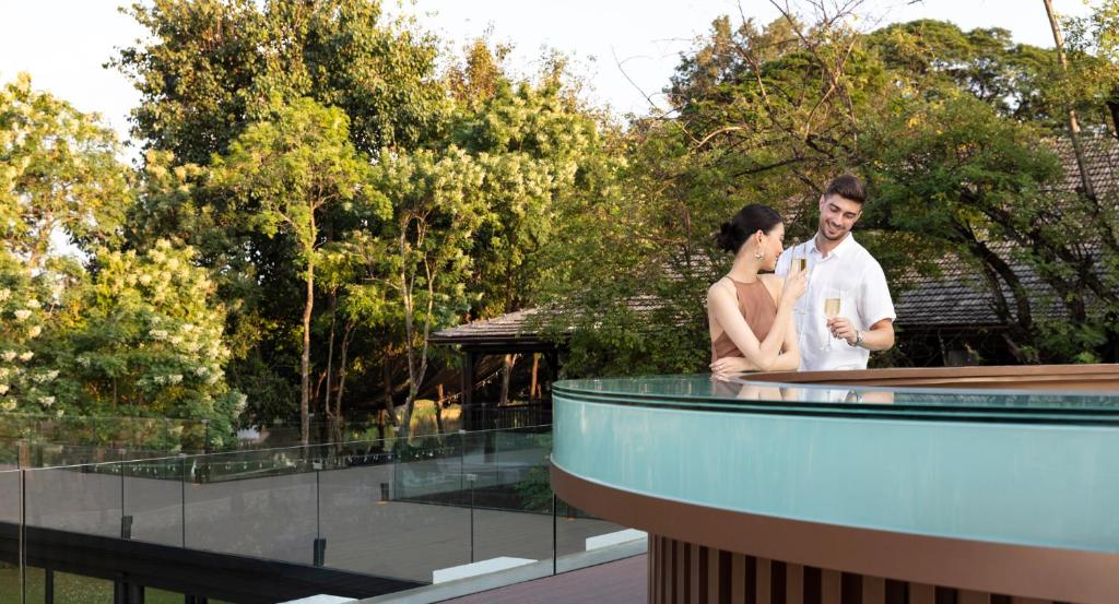 a man and a woman standing on top of a building at Anantara Chiang Mai Resort in Chiang Mai