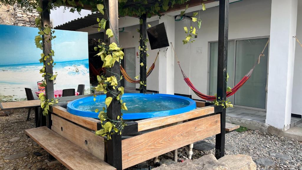 a jacuzzi tub in front of a house at Hotel Family House Rodadero in Santa Marta