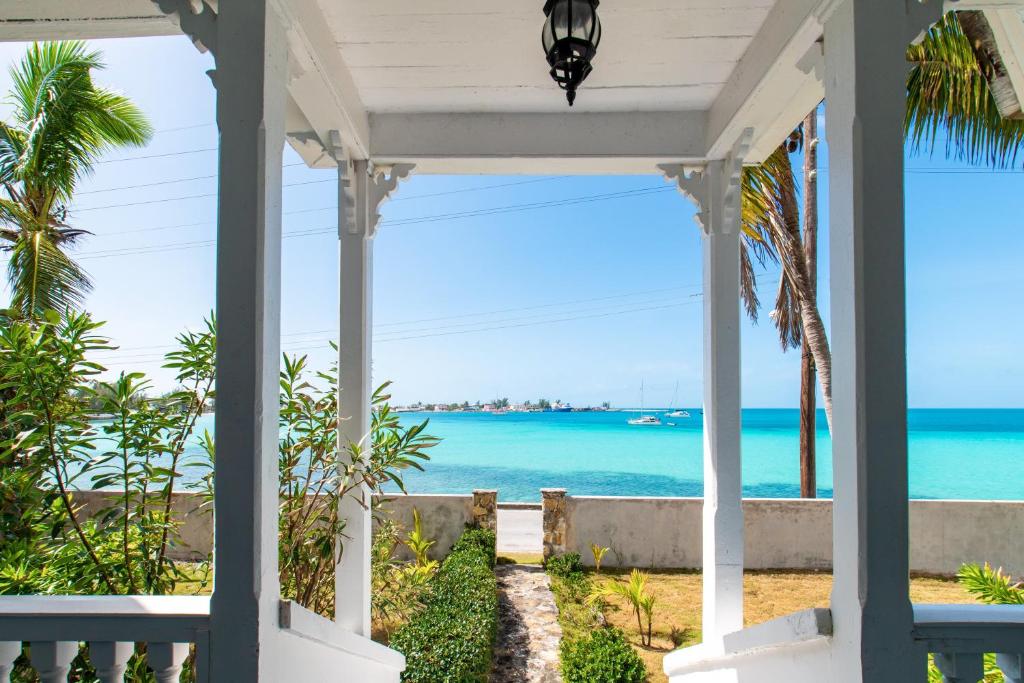 a porch with a view of the ocean at Folly home in Governorʼs Harbour