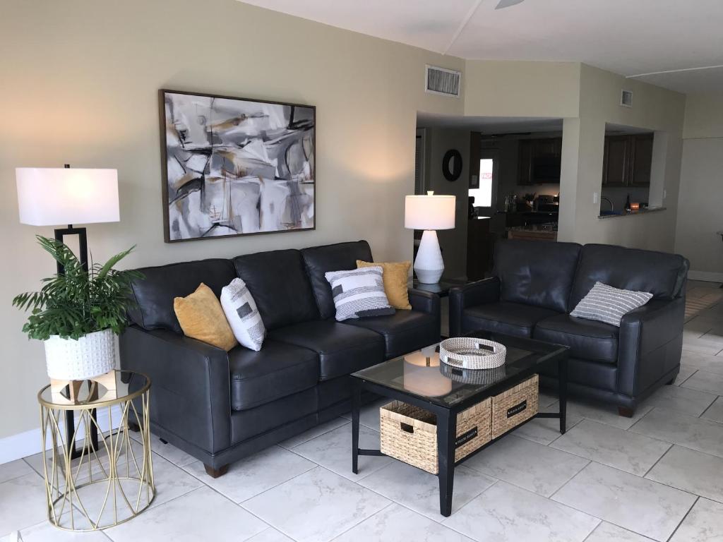 a living room with a black couch and a table at Island House Beach Resort 9N in Siesta Key