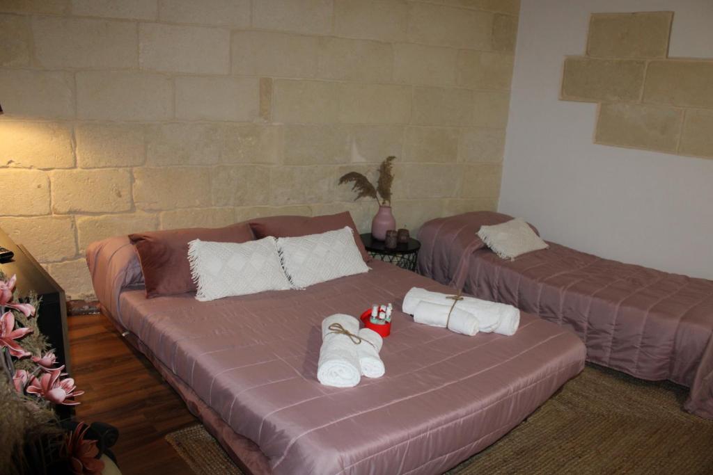 a couch with towels on it in a room at BETÌ in Taranto