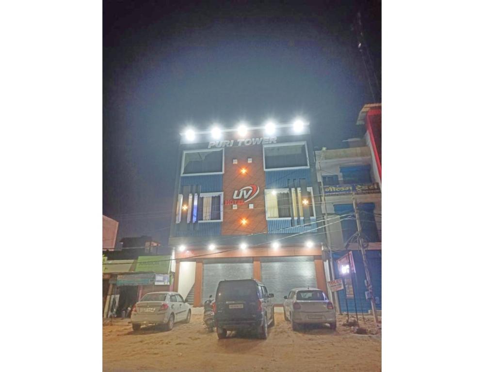 a double decker bus on top of a building at night at Hotel UV, Haryana in Nārnaul