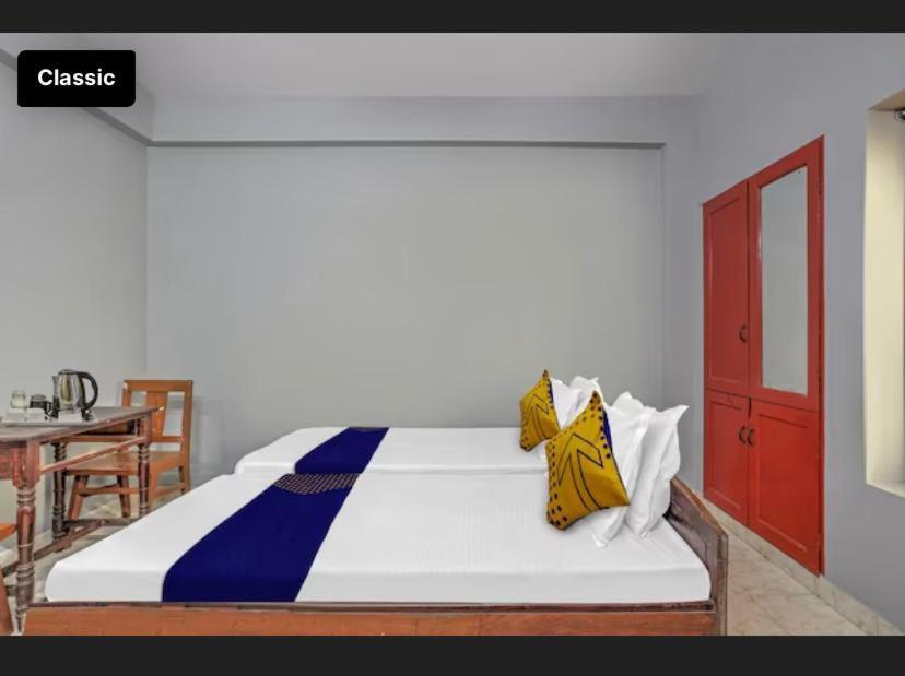 a bedroom with a large bed with a red door at KKP Tourist Home in Trivandrum