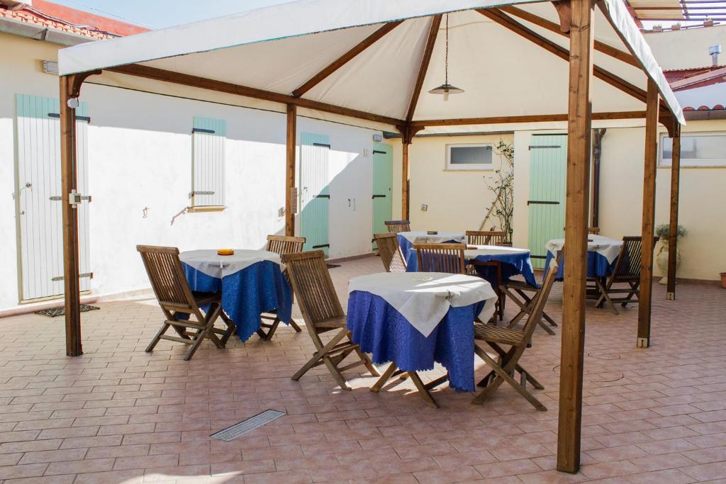 a group of tables and chairs under a tent at La Papaya in Marina di Pisa