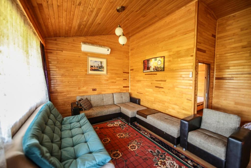 een kamer met een bank en stoelen in een kamer bij Villa Zeytin in Cıralı