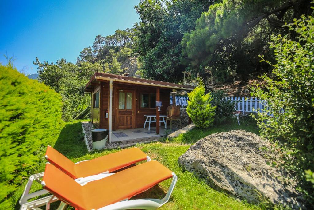 a small cabin with an orange chair in front of it at Villa Zeytin in Cıralı