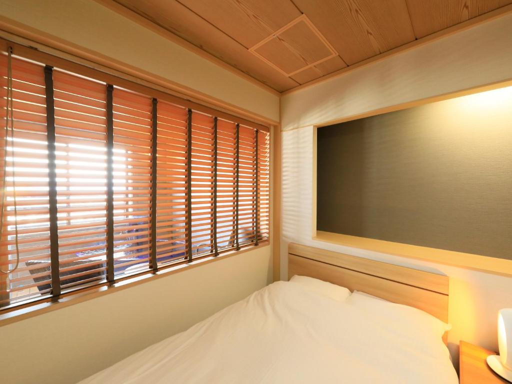 Postel nebo postele na pokoji v ubytování Hotel Tsubakino