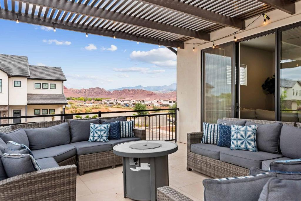 a patio with couches and a table on a balcony at Red Mountain Springs #23 townhouse in Santa Clara