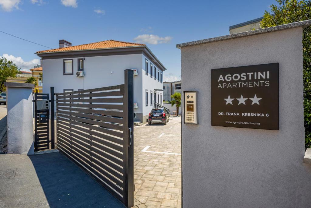 a building with a gate and a sign for a austin apartments at Agostini Residence - SELF CHECK-IN ONLY in Rijeka