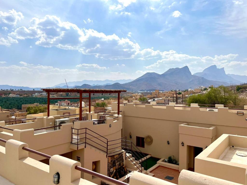 a view of a building with mountains in the background at Al Hamra Mountain View in Al Ḩamrāʼ