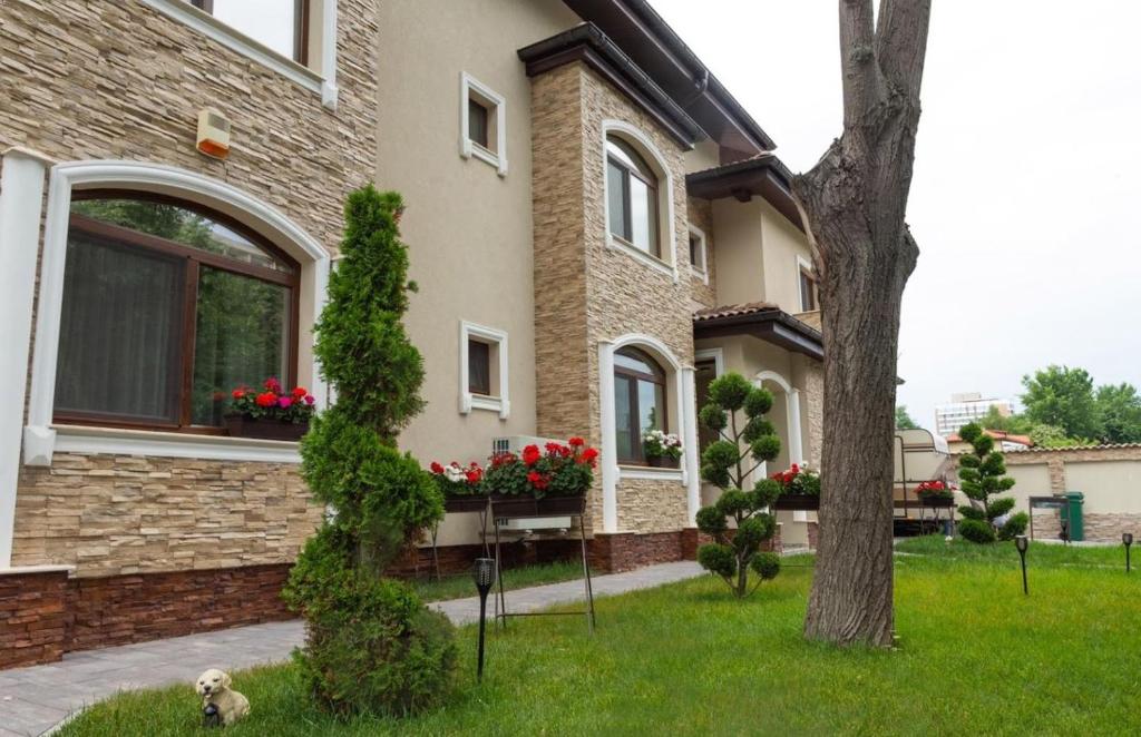a house with flower boxes on the windows at Vila Royal Mangalia in Mangalia
