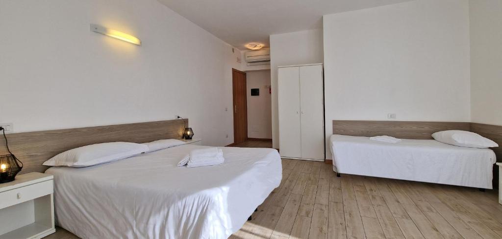 Postel nebo postele na pokoji v ubytování Hotel Beretta