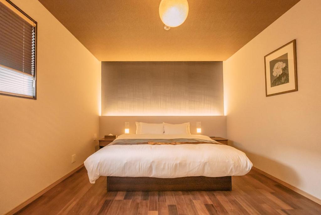 Postel nebo postele na pokoji v ubytování 谷町君 星屋 東山望月居