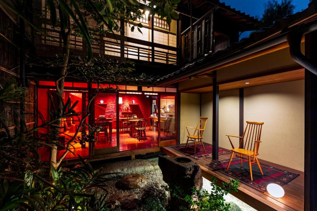 a house with a patio with chairs and a table at Rinn Shiki Juraku in Kyoto