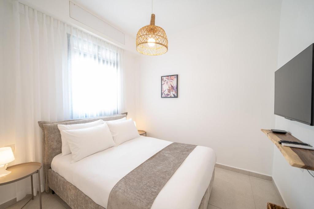Postel nebo postele na pokoji v ubytování Chita Ella sun