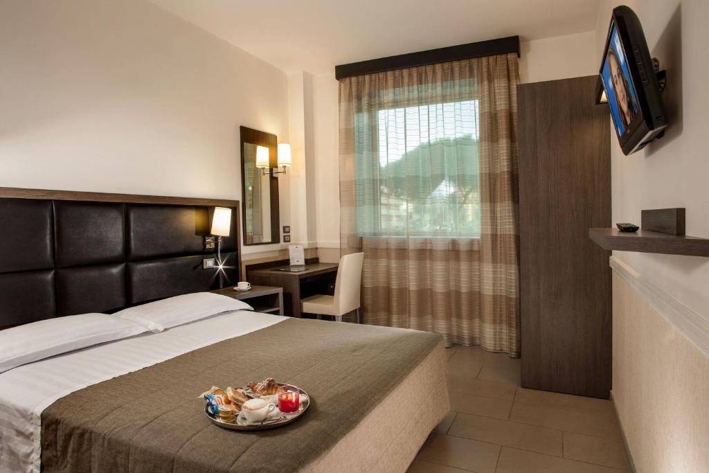 Postel nebo postele na pokoji v ubytování Hotel Artis