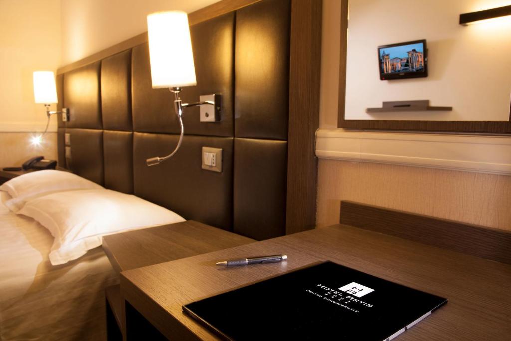 Postel nebo postele na pokoji v ubytování Hotel Artis