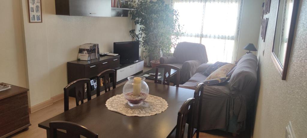 a living room with a table and a couch at apart paz in Torrevieja