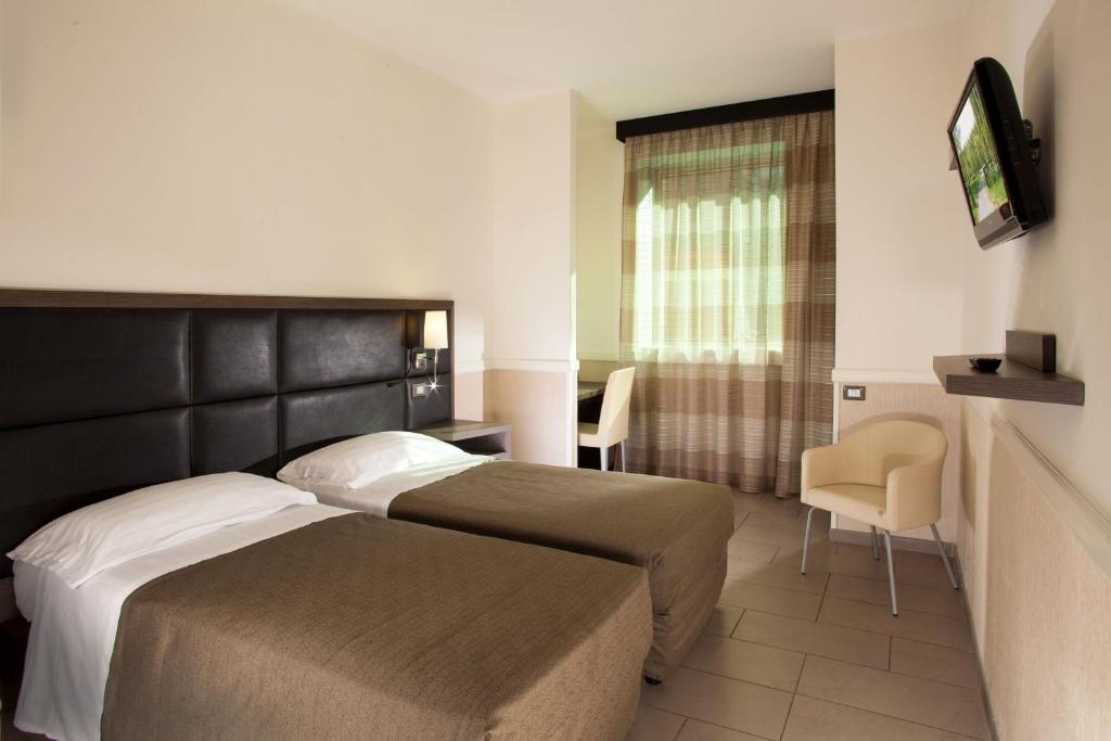 Postel nebo postele na pokoji v ubytování Hotel Artis