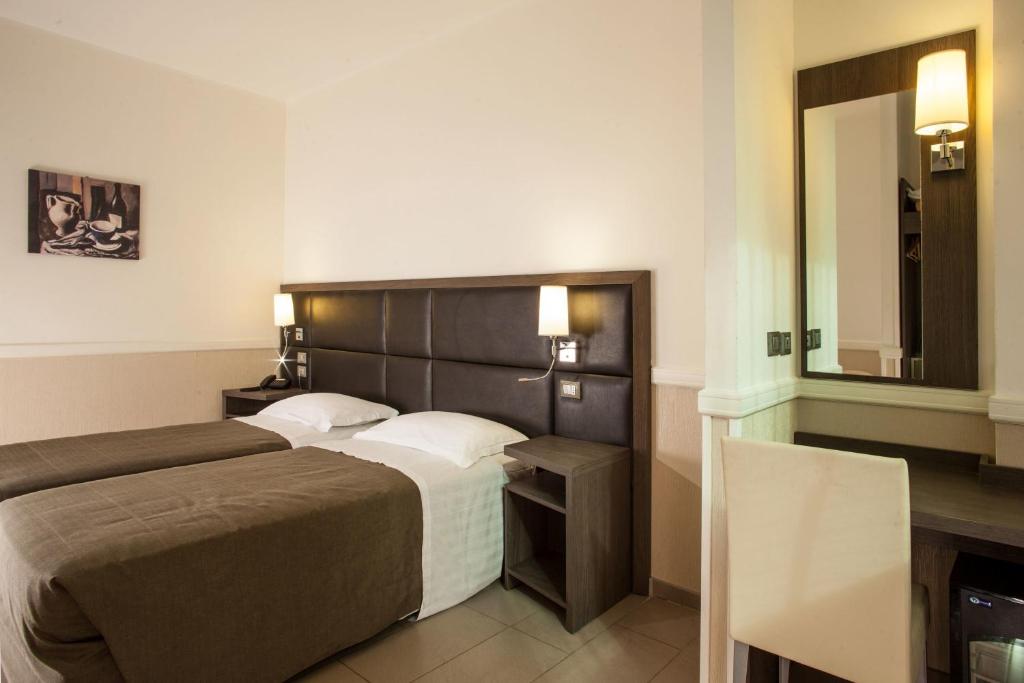 Postel nebo postele na pokoji v ubytování Hotel Artis