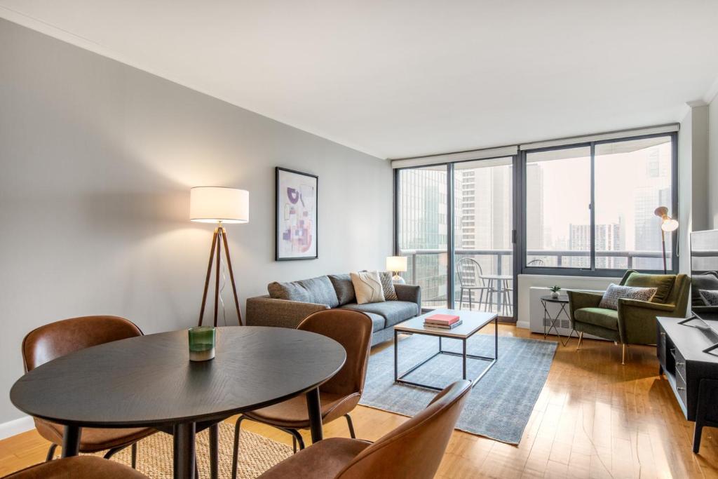 a living room with a couch and a table at Midtown 2BR w Pool Gym Roof nr Broadway NYC-382 in New York