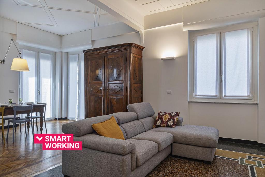 a living room with a couch and a table at Beauty & Design in the Center by Wonderful Italy in Genova