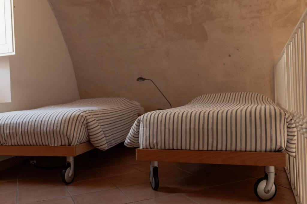 Postel nebo postele na pokoji v ubytování Il Vicinato, casa vacanza immersa nel cuore dei Sassi