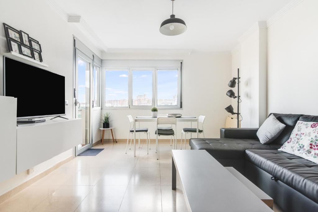 een woonkamer met een bank en een tafel bij Home2Book Stylish&Comfy Apartment Rambla, Terrace in Las Palmas de Gran Canaria