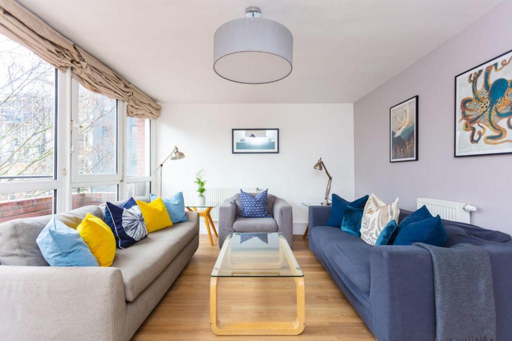a living room with two couches and a table at Spacious Central 3 Bedroom Apartment in Old Street in London