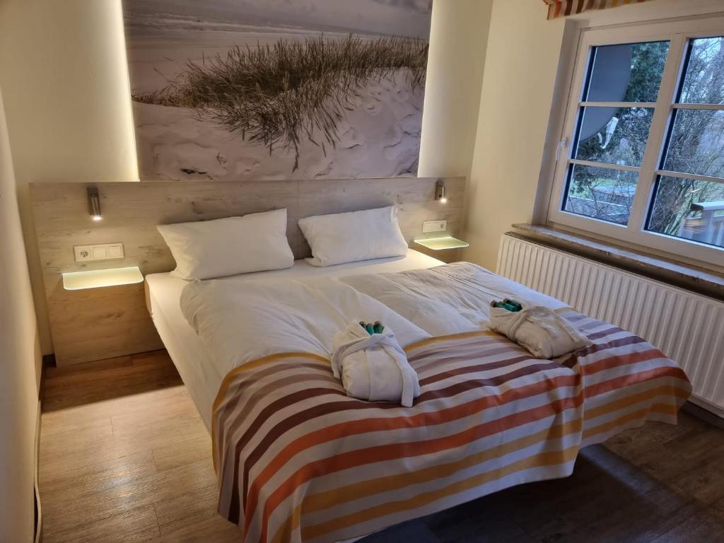 Postel nebo postele na pokoji v ubytování Hotel Osterkrug