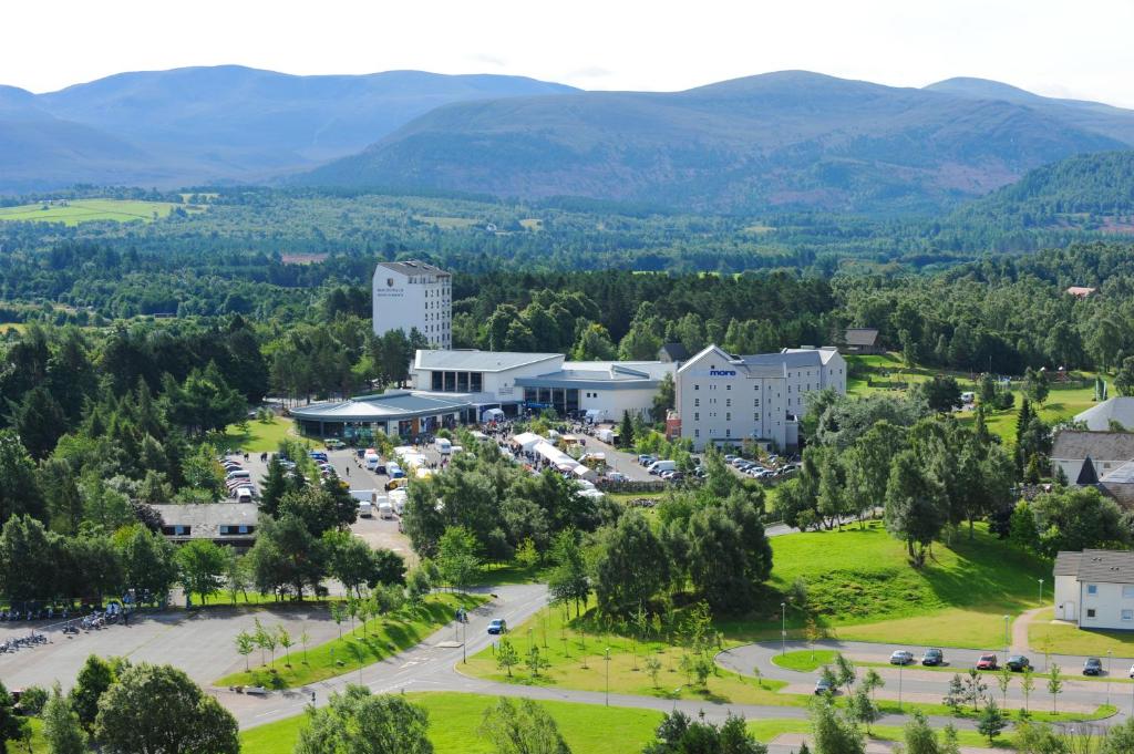 an aerial view of a town with mountains in the background at Macdonald Morlich Hotel at Macdonald Aviemore Resort in Aviemore