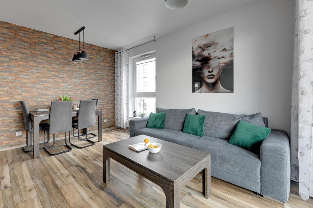 a living room with a couch and a table at Bastion View TriApart in Gdańsk