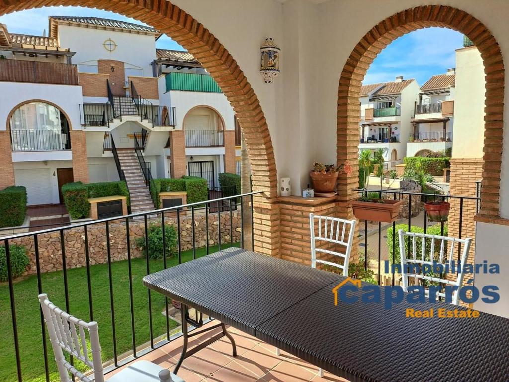 a patio with a table and chairs on a balcony at Apartamento 2 Al Andalus Resort - Vera Playa in Vera
