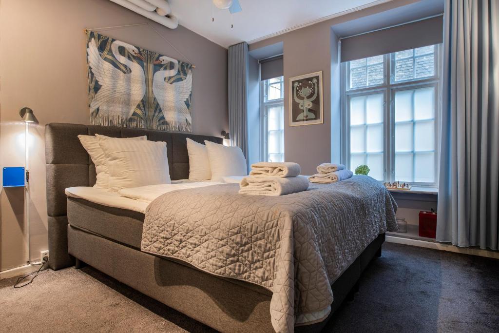 a bedroom with a large bed with towels on it at The Churchill 5 by Daniel&Jacob's in Copenhagen