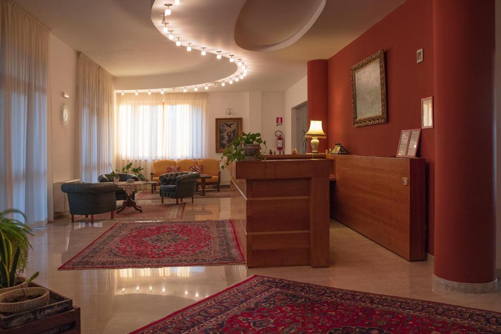 a lobby with a reception desk and a living room at Ruggiero Park Hotel in Vallo della Lucania