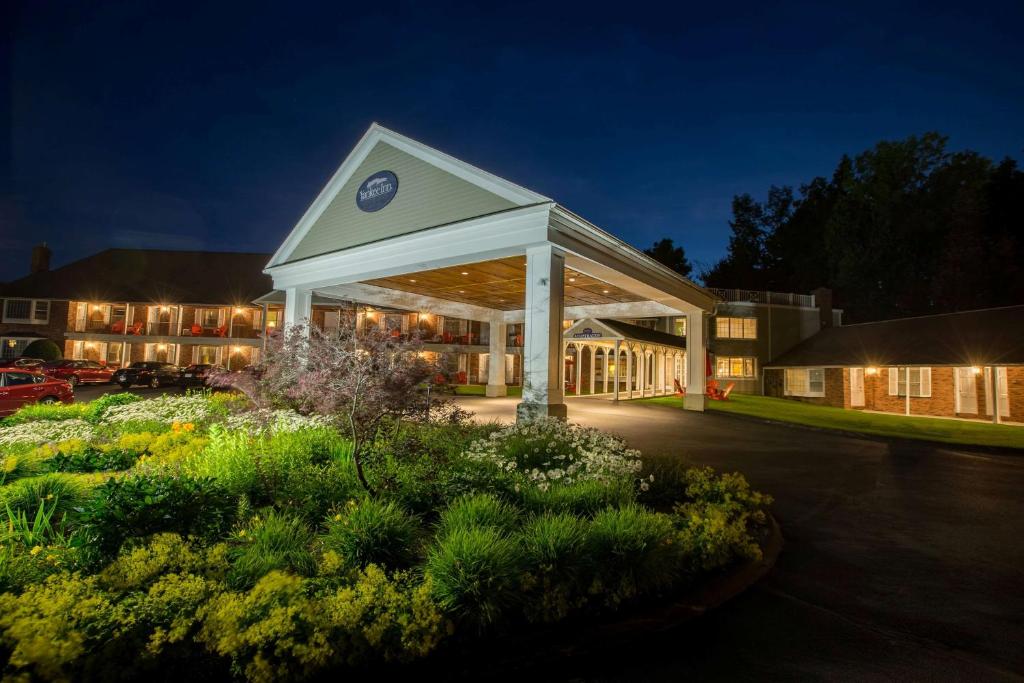 a building with a clock on top of it at night at The Yankee, Trademark Collection by Wyndham in Lenox