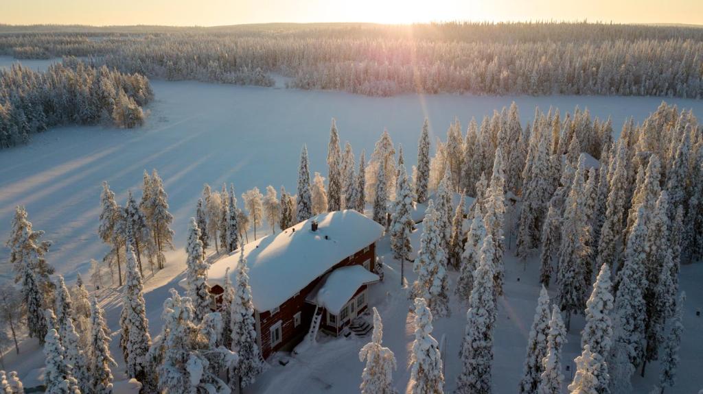 an old truck covered in snow in a snow covered forest at Iisakki Village in Ruka