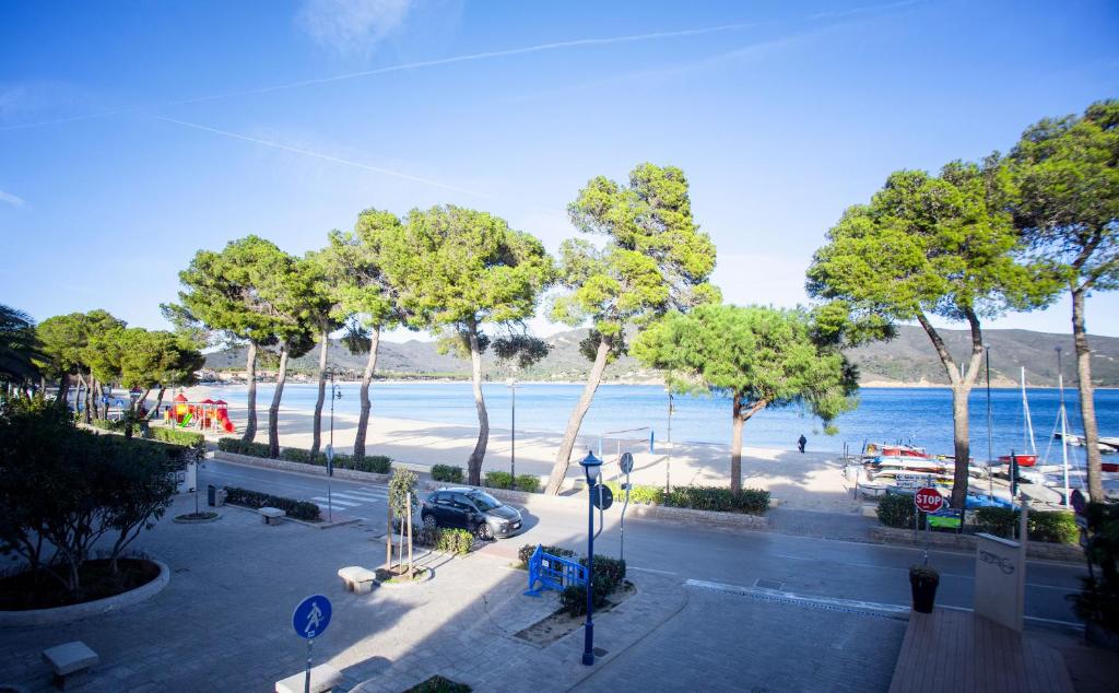 a view of a beach with trees and the water at Vistamare Suite & Room in Marina di Campo
