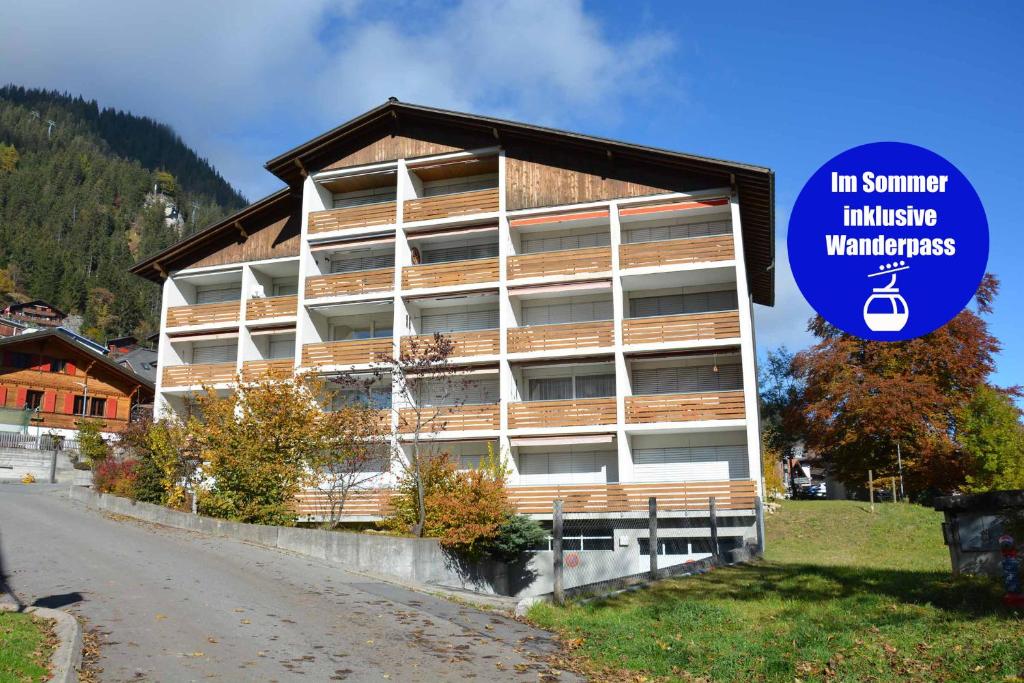 a building with a blue sign in front of it at Ferienwohnung Studio Selvea in Adelboden